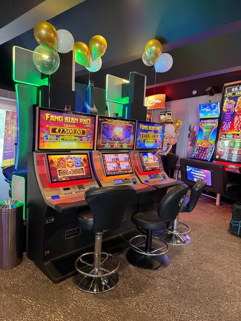 Slot machines beneath colourful balloons at Casino JOA d'Argelès