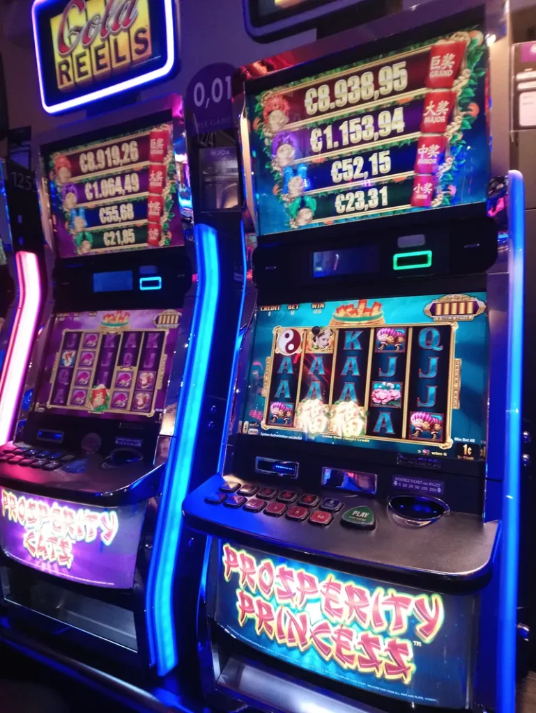 Tall illuminated slot machine at Casino JOA de Canet