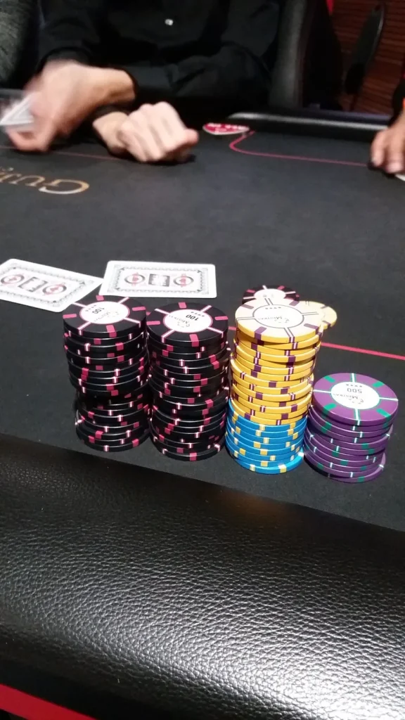 Poker chips and cards on a gaming table at Casino JOA de Gujan-Mestras