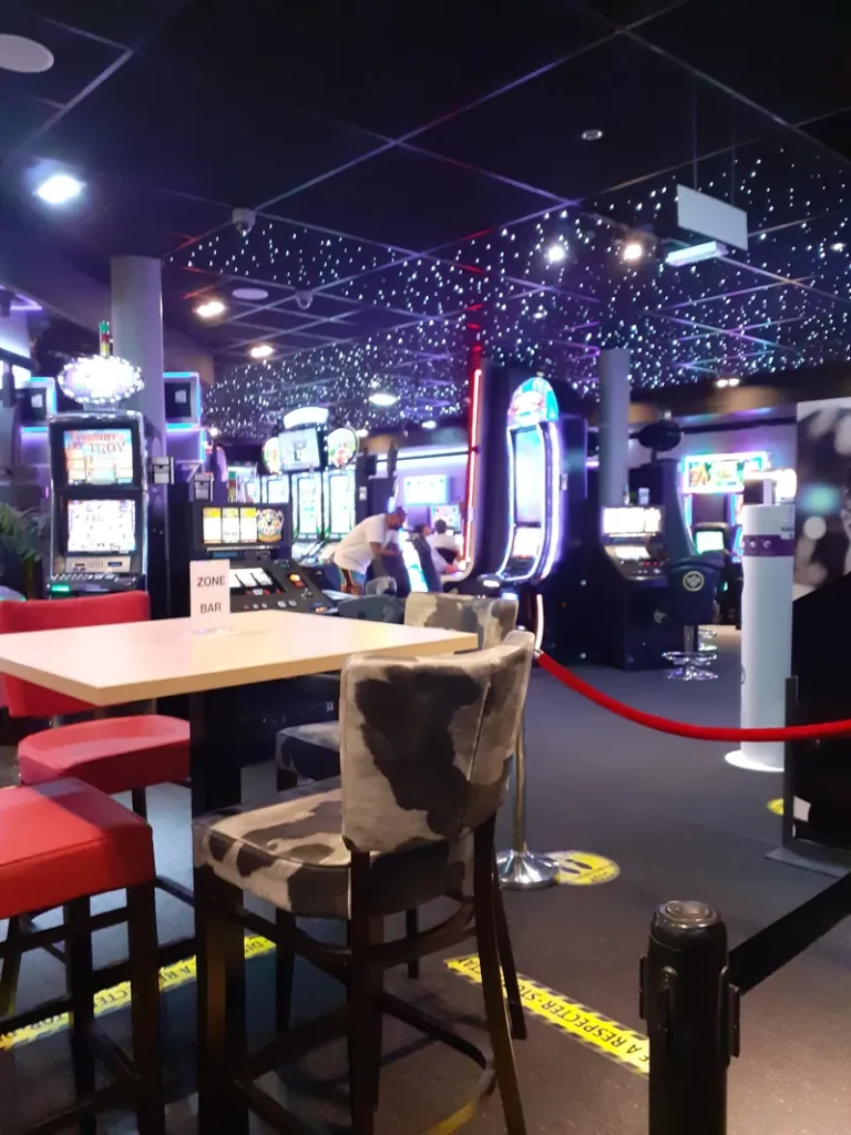 Slot machines beside lounge seating at Casino JOA de Saint-Cyprien