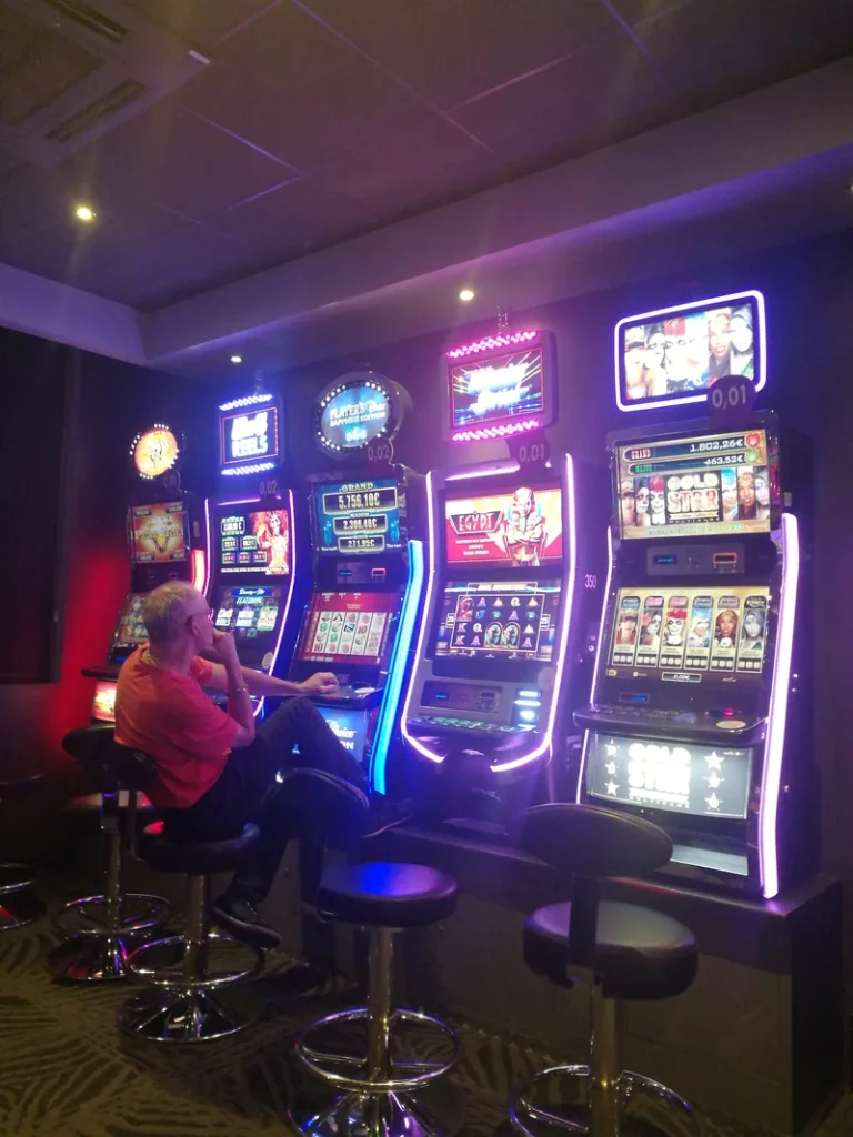 Purple-lit row of slots at Casino JOA de Santenay