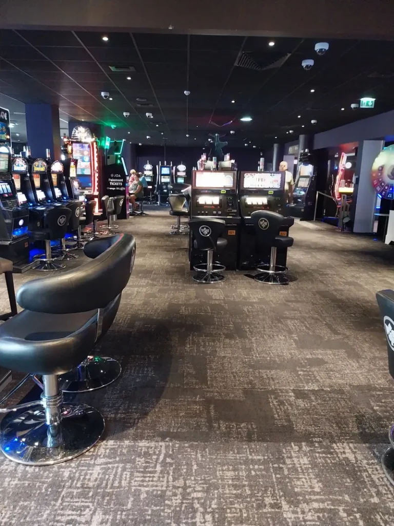 Gaming floor with slots and seating at Casino JOA Les Pins des Sables d'Olonne
