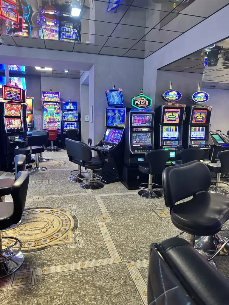 Slot machine lounge with patterned carpet at Casino Castéra-Verduzan