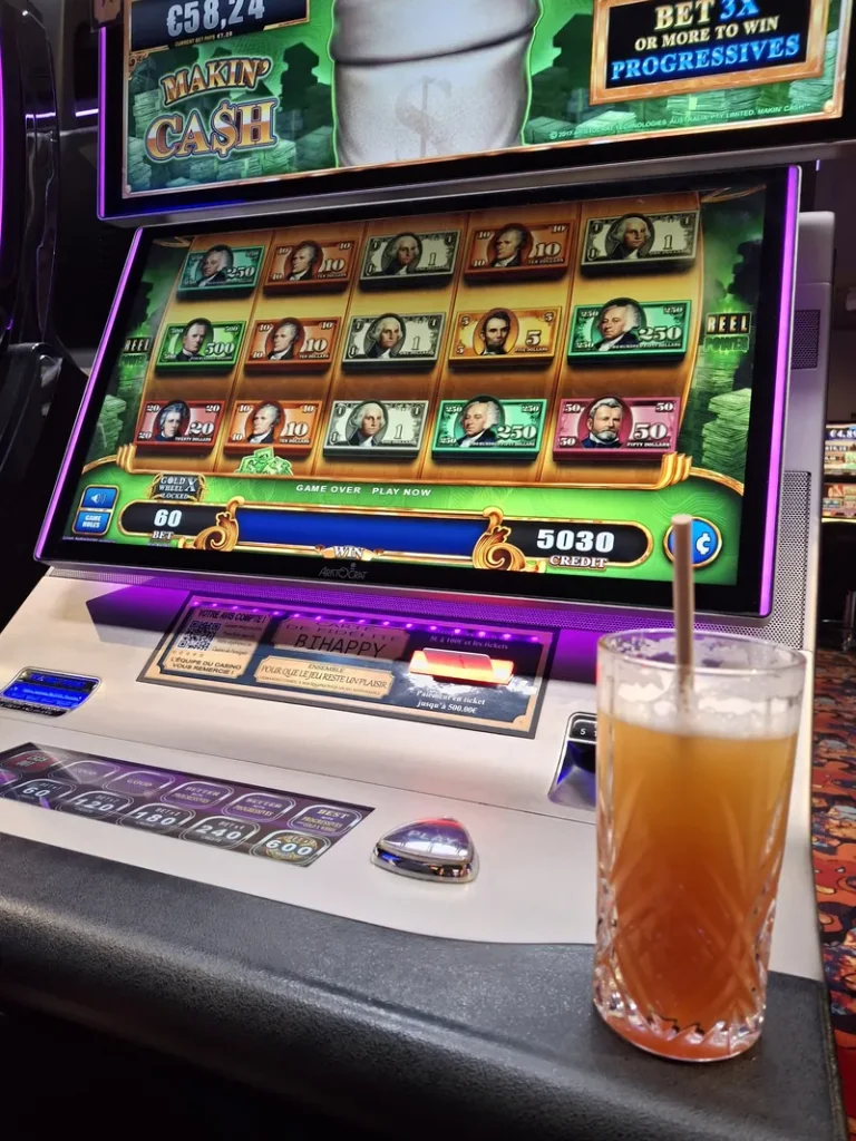 Slot machine with a drink at Casino de Houlgate