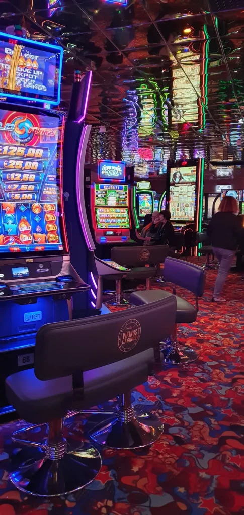 Row of illuminated slot machines at Casino de Sanary