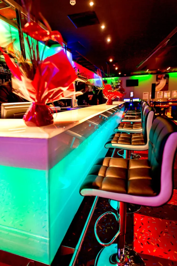 Colourfully lit bar and seating at Circus Casino Briançon